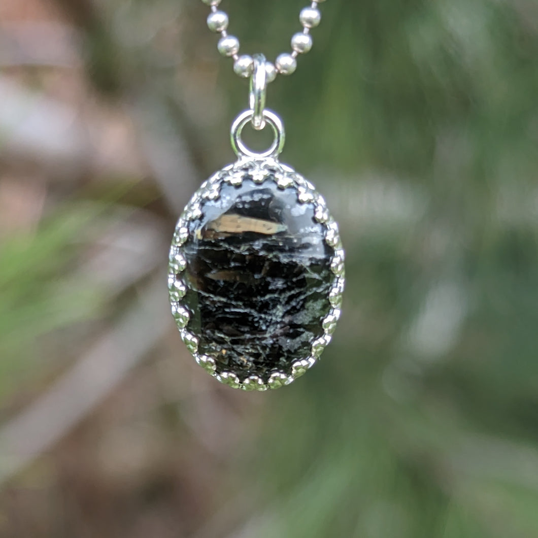 Nuummite with magnetic Pyrrhotite inclusions in 925 silver